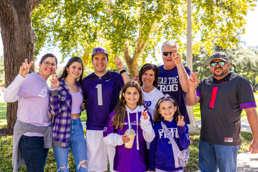 A family of Horned Frog fans pose for a photo before TCU's homecoming football game against Brigham Young University at Amon G. Carter Stadium. Final score: TCU 44, BYU 11. Photo by James Anger, October 14, 2023.